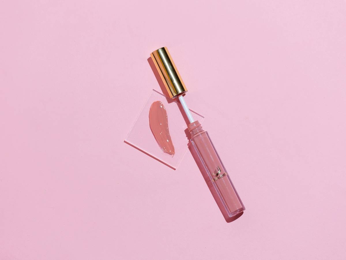 Close-up of a cosmetic concealer brush applying product under the eye