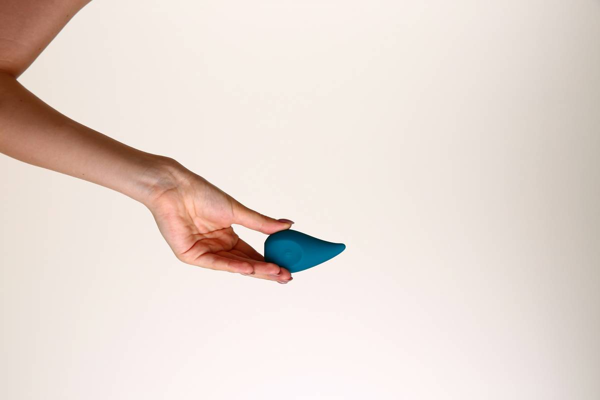 A woman holding a blue object in her hand