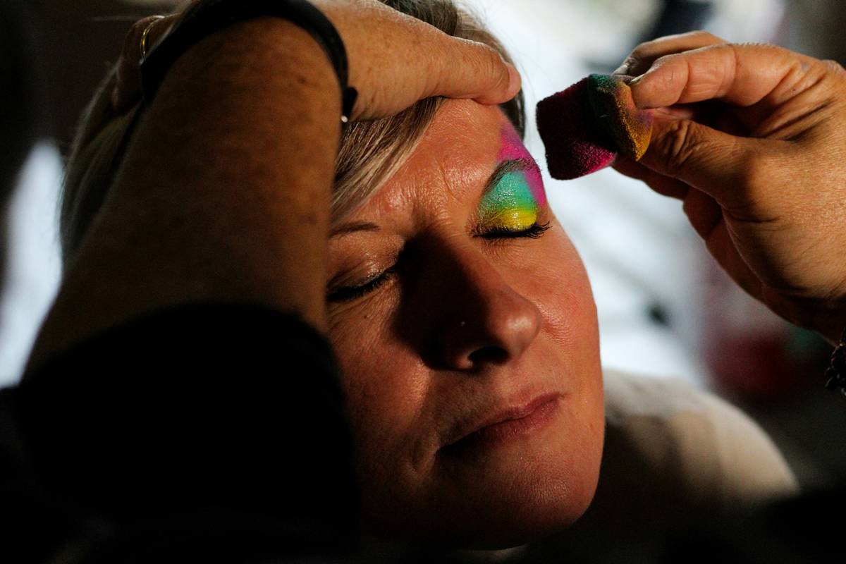Close-up of a makeup eyeshadow sponge applying shimmer pigment to eyelid
