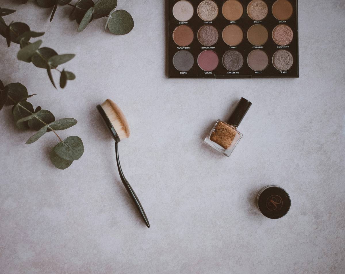 Close-up of a beauty highlighting tool applying shimmer to cheekbone